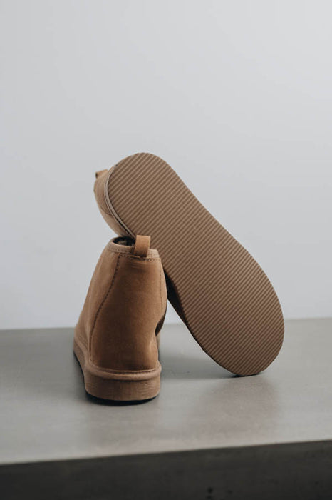 Noah Tabac Sheepskin Slippers showing the bottom of the EVA sole on a Concrete Surface