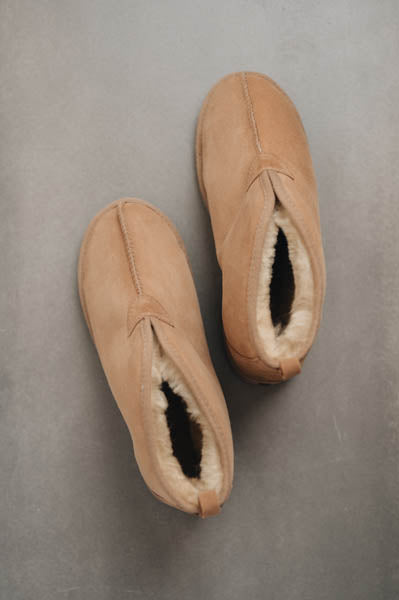 Birds eye view of Noah Tabac Sheepskin Slippers on Concrete Surface