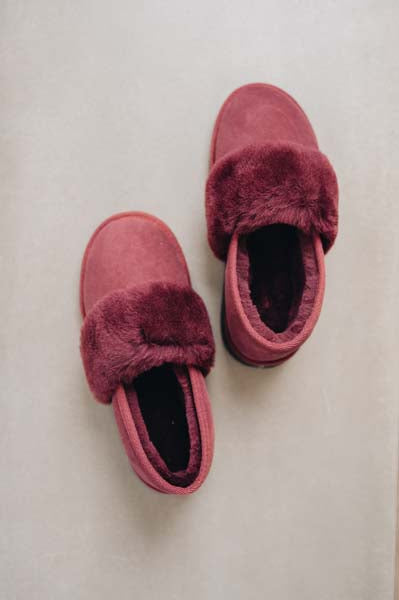 Birds eye view of Margot Merino Sheepskin Slippers in a rich Bordeaux colour on a Concrete Surface