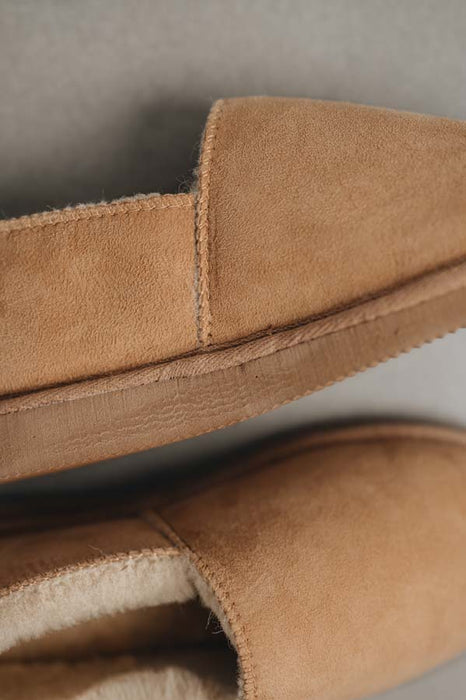 Close up  of Tan coloured loafer style sheepskin slipper 