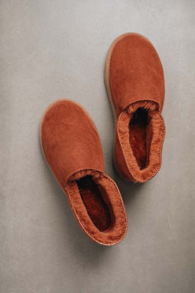 Birds eye view of Rust loafer style men's sheepskin slipper showing plush natural sheepskin wool inside