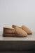 Side view of clean loafer style sheepskin slipper, hand crafted from Spanish merino sheepskin.