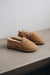 Side view of clean loafer style sheepskin slipper, hand crafted from Spanish merino sheepskin.