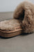 Close up view of Veronica Taupe Sheepskin Slippers with Heatons label detail on Concrete Surface