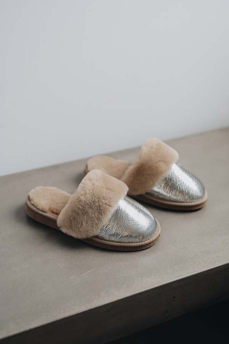 Side view of Veronica Titanium Sheepskin Slippers on Concrete Surface