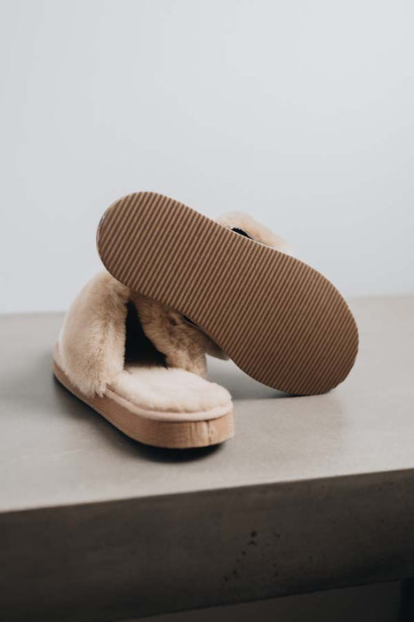 Veronica Titanium Sheepskin Slippers showing the bottom of the EVA sole on a Concrete Surface