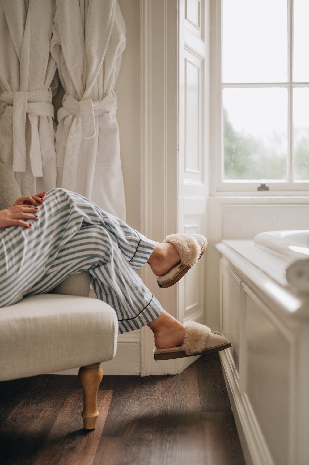 Womens Sheepskin Slippers walking across the carpet keeping feet warm