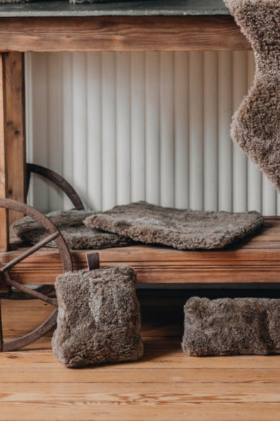 padded seat p[ads in square and circle style, made of brown patchwork sheepskin
