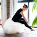 White Full Sheepskin Yoga / Exercise Ball. Model sat on top.