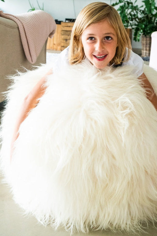 White Full Sheepskin Yoga / Exercise Ball. Child sat on top.