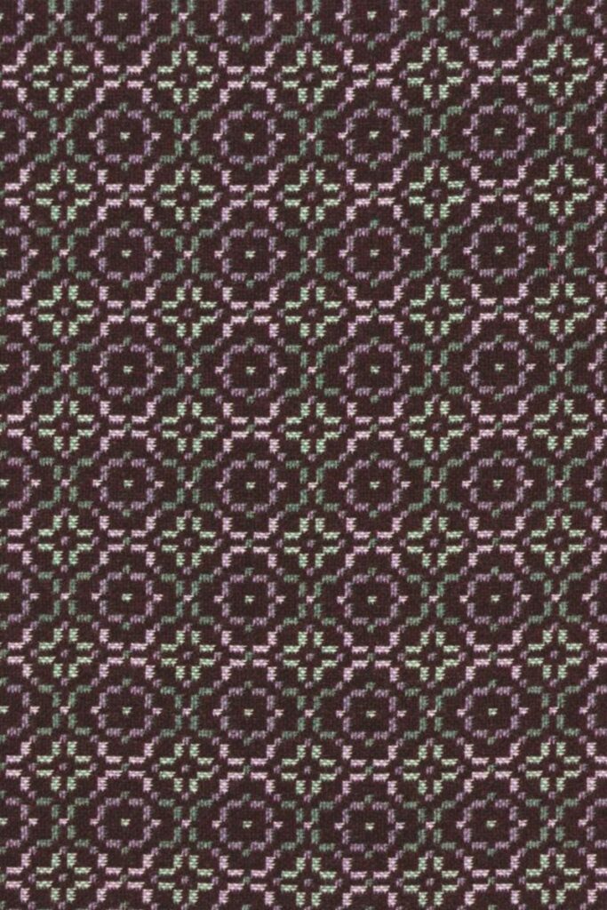 Melin Tregwynt woven wool throw or blanket in dark purple with lilac and grey Vintage Rose pattern repeat
