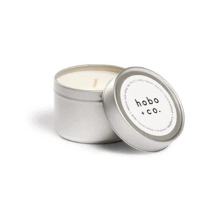 Small silver tin candle with lid off to show white soy wax and cotton wick