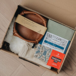 gift box with leather bowl, apron, hot water bottle and tea bag