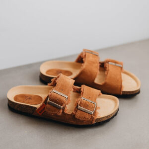 high angle of the sandals and their metal buckle