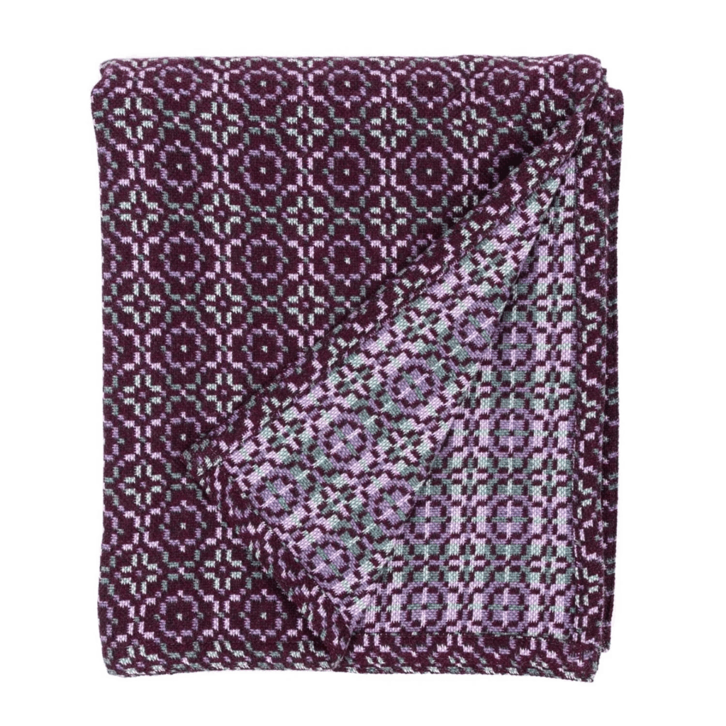 woven wool throw or blanket in dark purple with lilac and grey pattern details