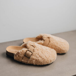 Seren vanilla outdoor slip on mule with curly vanilla sheepskin on the outside and an adjustable strap and buckle