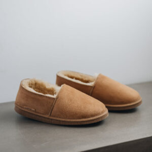 Side view of clean loafer style sheepskin slipper, hand crafted from Spanish merino sheepskin.