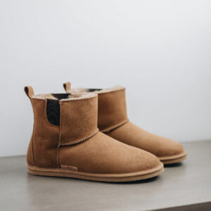Side view of the Sheepskin, Chelsea boot style, slipper. A classic sheepskin boot with elastic panels on both sides.