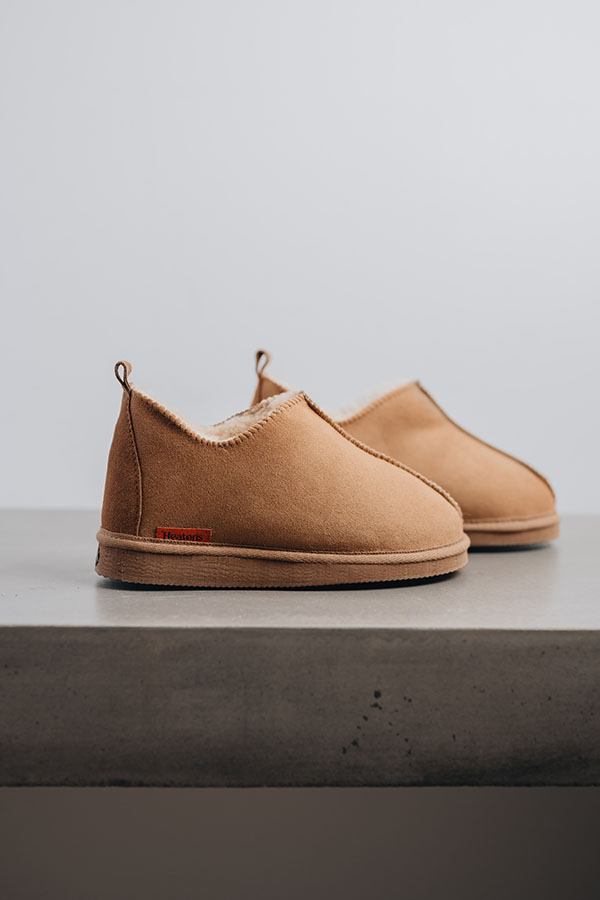 Side view of Henry men’s sheepskin boot slippers in tabac with sole detail by Heatons